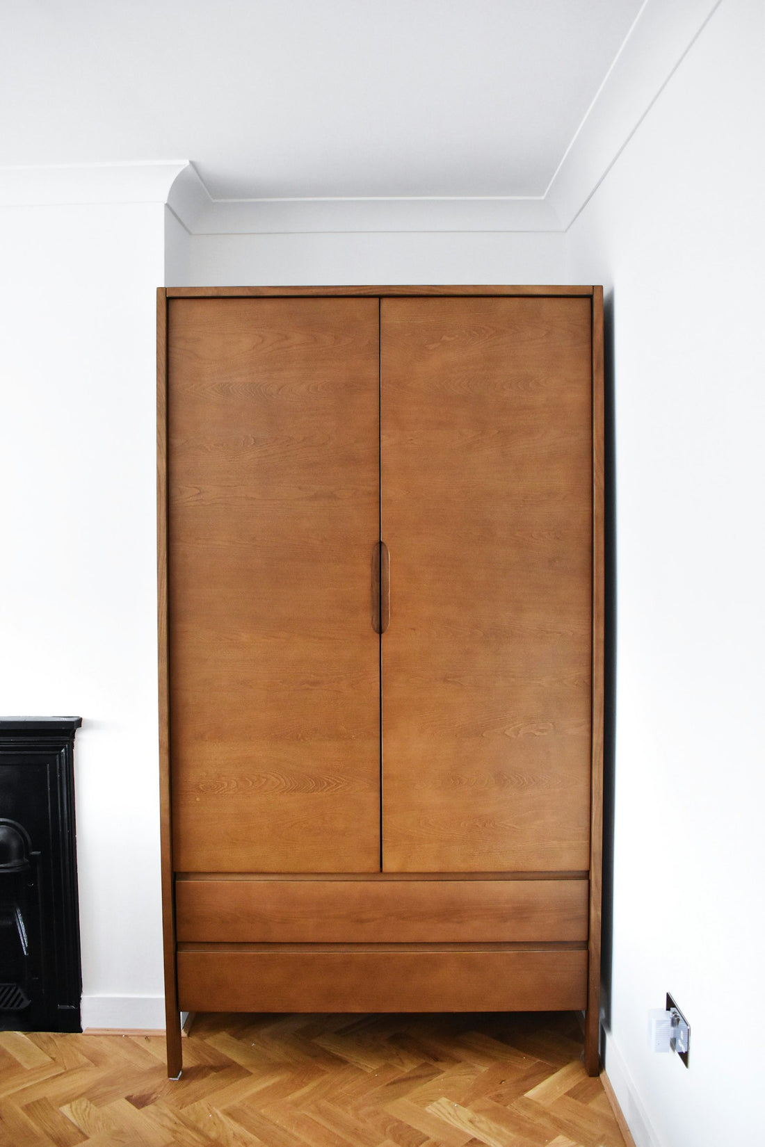 Open-plan space correctly zoned with pendant over dining table, generously sized dining rug with chairs comfortably on it, and sofa oriented as a soft zone boundary between living and dining areas